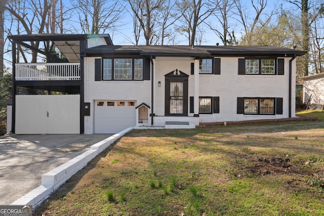 bi-level home featuring driveway, a garage, a front yard, and brick siding