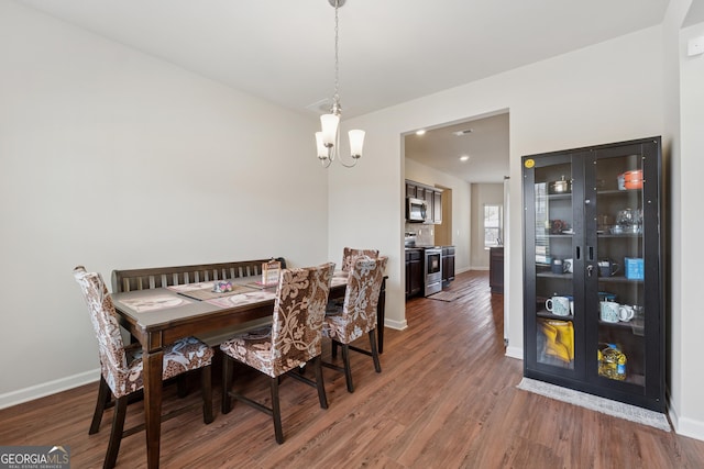 dining room featuring wood finished floors and baseboards