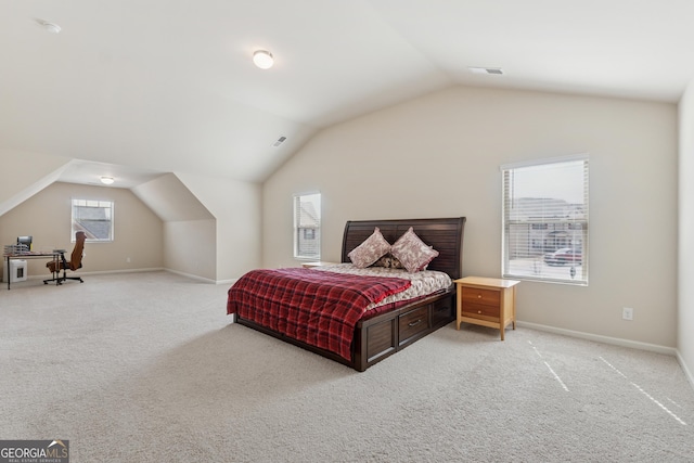 bedroom with visible vents, carpet flooring, and vaulted ceiling