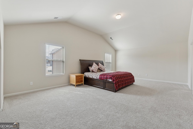 bedroom featuring vaulted ceiling, carpet, visible vents, and baseboards