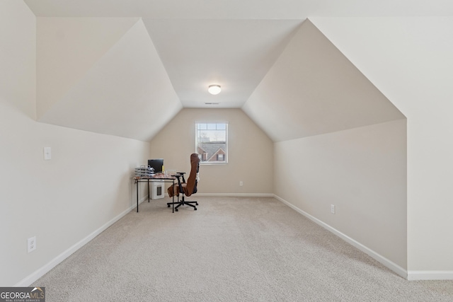 carpeted office with baseboards and lofted ceiling