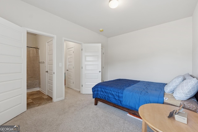 carpeted bedroom with lofted ceiling