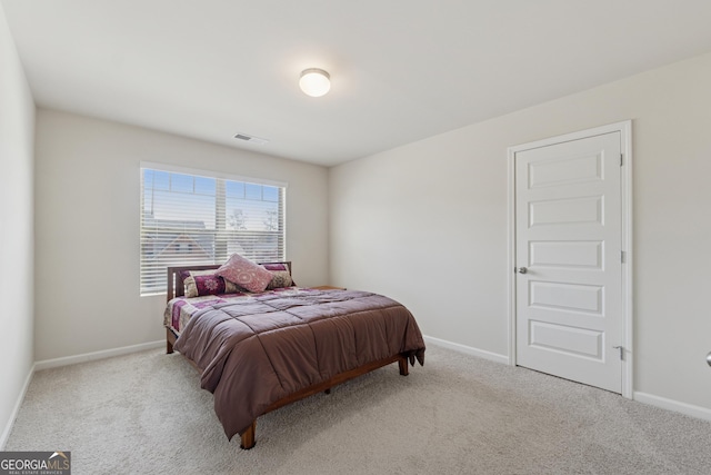 carpeted bedroom with visible vents and baseboards