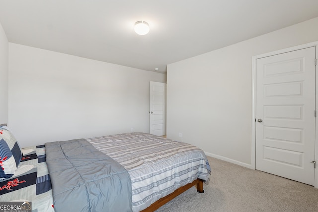 carpeted bedroom featuring baseboards