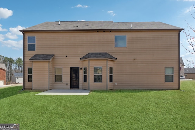 rear view of property featuring a patio area and a lawn