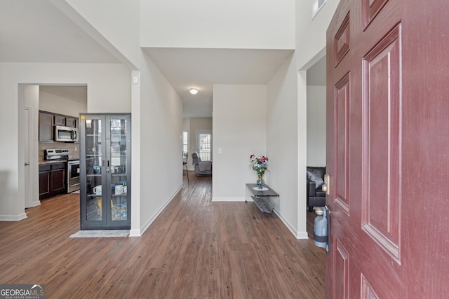 entryway featuring baseboards and wood finished floors