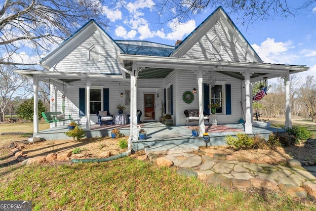 view of front facade featuring a porch and a chimney