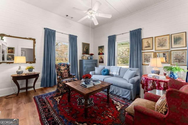 living room featuring wood finished floors and a ceiling fan