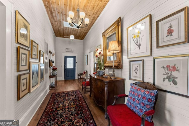 entryway with wooden ceiling, wood finished floors, and an inviting chandelier