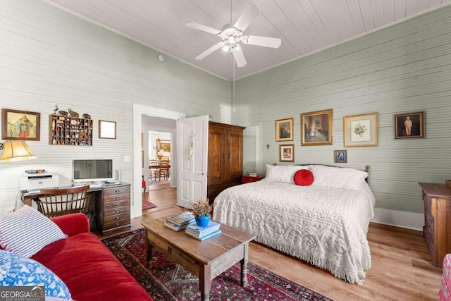 bedroom featuring ceiling fan, baseboards, and wood finished floors