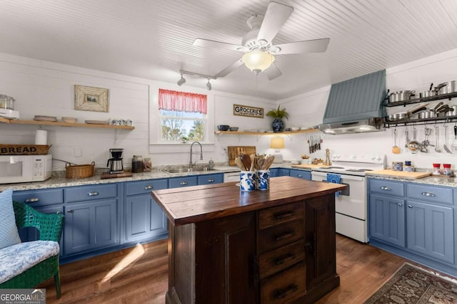 kitchen featuring blue cabinets, white appliances, butcher block counters, and open shelves