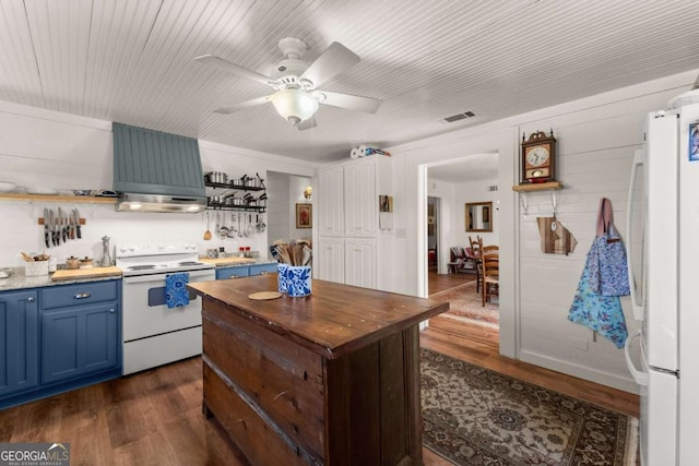 kitchen featuring white appliances, dark wood-style floors, butcher block counters, blue cabinetry, and open shelves