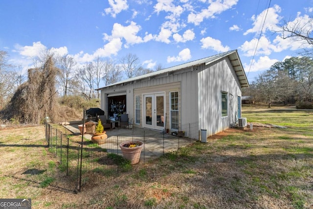 rear view of house with a yard, ac unit, a patio, and french doors