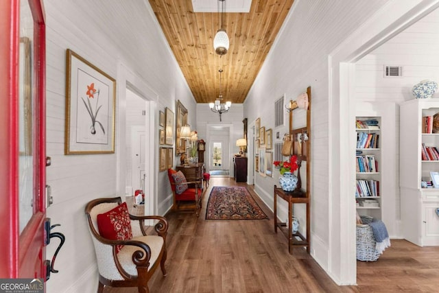 corridor with a chandelier, wood ceiling, visible vents, and wood finished floors