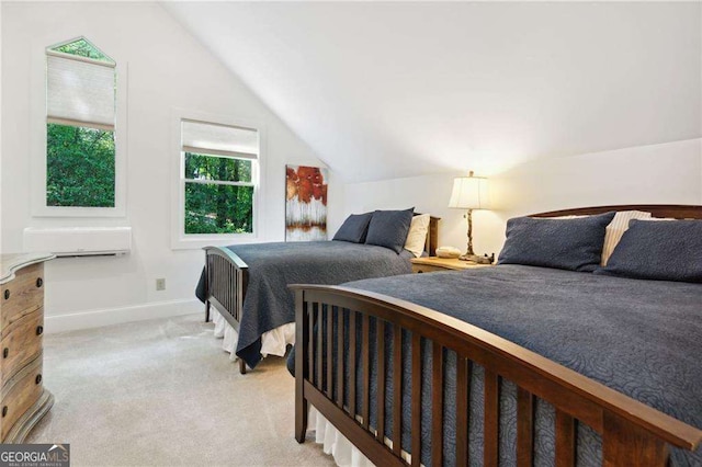 bedroom with lofted ceiling, light colored carpet, and baseboards