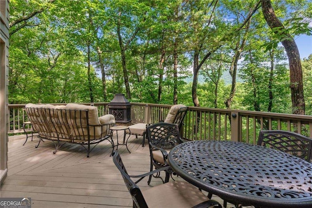 wooden deck featuring outdoor dining space