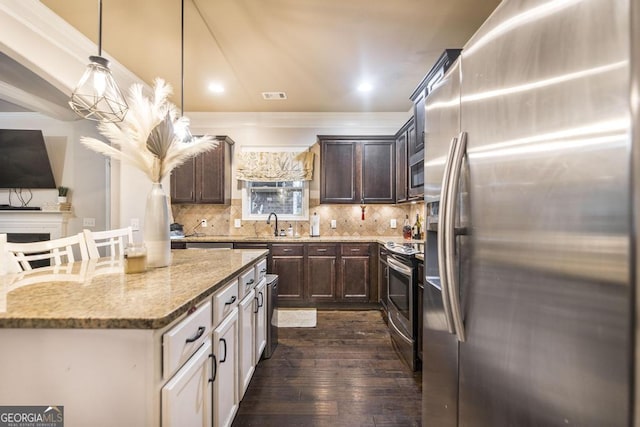 kitchen featuring light stone counters, visible vents, decorative backsplash, appliances with stainless steel finishes, and dark brown cabinetry