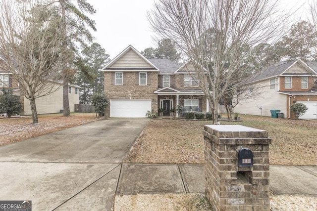 view of front of home featuring a garage, driveway, and brick siding