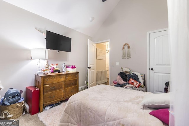 bedroom featuring high vaulted ceiling and carpet flooring