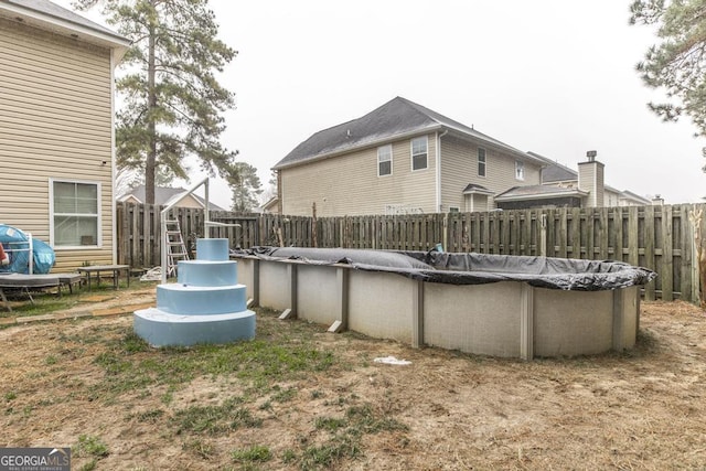 exterior space featuring a fenced backyard and a fenced in pool