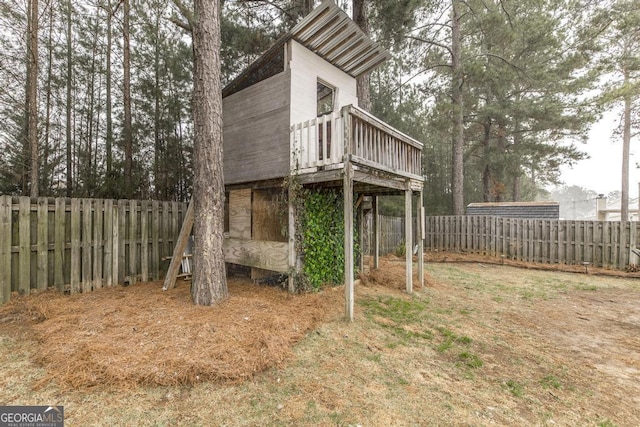 exterior space with a fenced backyard and a deck