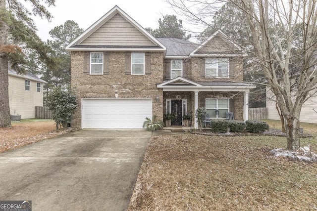 traditional-style house with a garage, a porch, concrete driveway, and brick siding