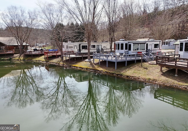 dock area featuring a deck with water view