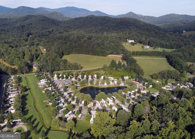 aerial view with a forest view and a water and mountain view