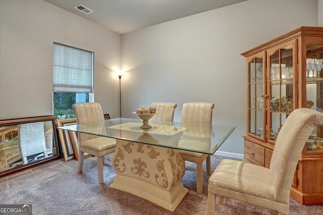 carpeted dining area with visible vents