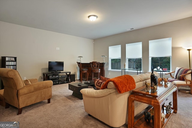 living area with carpet floors and visible vents