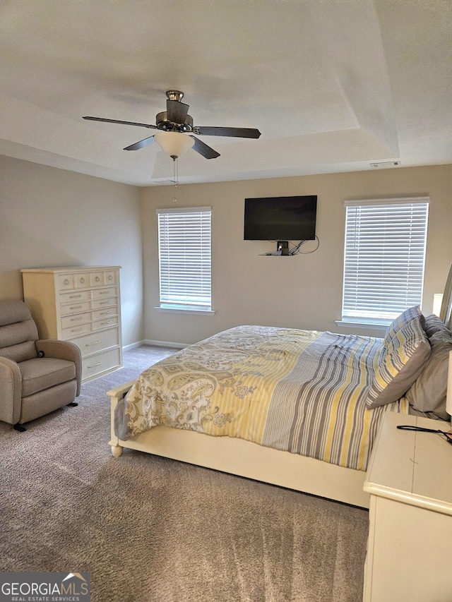 bedroom featuring baseboards, carpet flooring, visible vents, and a ceiling fan