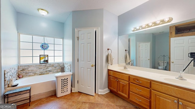 bathroom with tile patterned floors, a garden tub, a sink, and double vanity