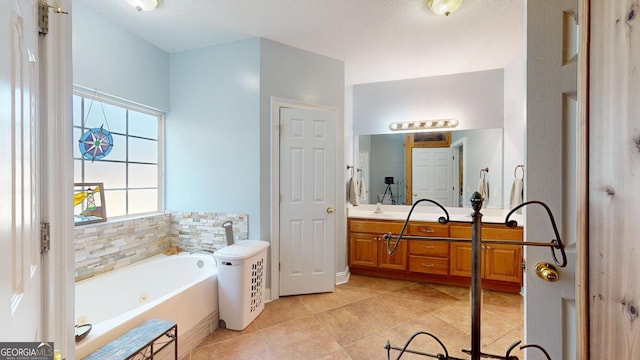 bathroom featuring tile patterned floors, vanity, and a bath