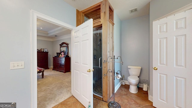 full bath featuring visible vents, toilet, ornamental molding, tile patterned flooring, and a shower stall