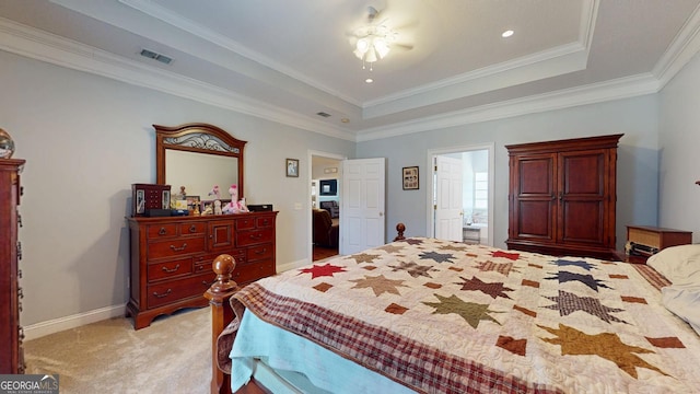 bedroom featuring a tray ceiling, visible vents, ornamental molding, light carpet, and baseboards