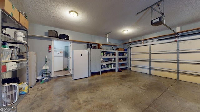 garage featuring a garage door opener and freestanding refrigerator