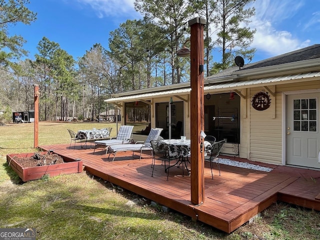 wooden terrace with a yard