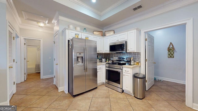 kitchen with visible vents, stainless steel appliances, light countertops, white cabinetry, and light tile patterned flooring