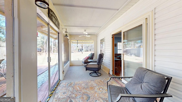 sunroom / solarium with a ceiling fan