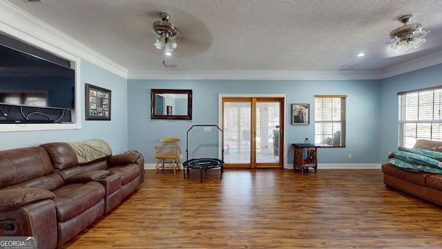 living area with baseboards, ceiling fan, ornamental molding, and wood finished floors