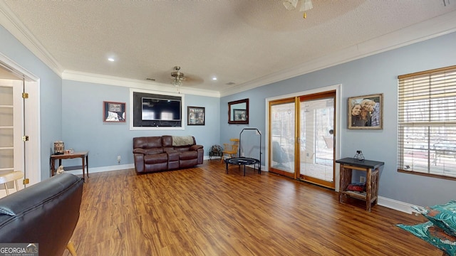 living room with baseboards, ornamental molding, wood finished floors, a textured ceiling, and recessed lighting