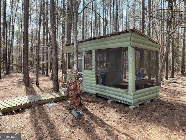 view of outdoor structure featuring a sunroom