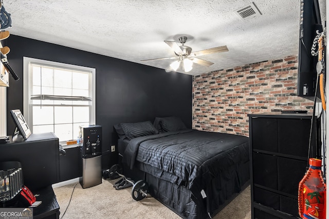 bedroom with carpet, visible vents, brick wall, ceiling fan, and a textured ceiling