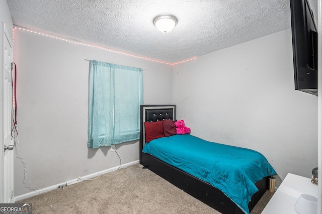 carpeted bedroom with baseboards and a textured ceiling