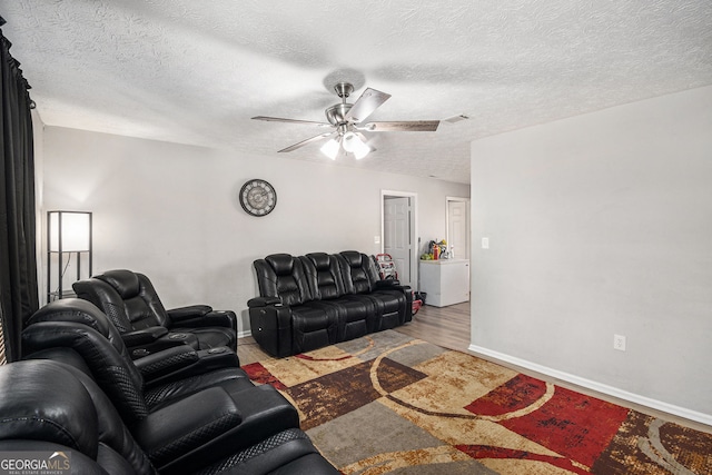 living area with visible vents, baseboards, ceiling fan, and wood finished floors