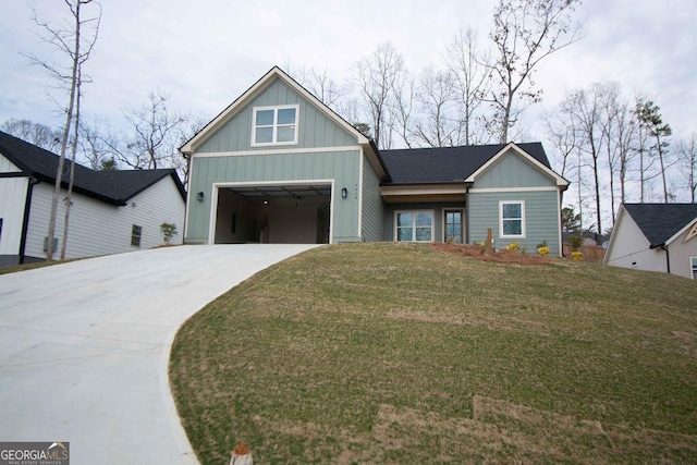 view of front of property with a front lawn, board and batten siding, and concrete driveway