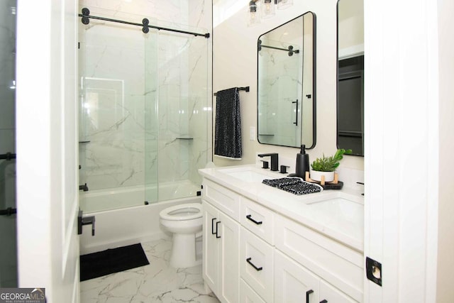 full bath featuring marble finish floor, double vanity, bath / shower combo with glass door, toilet, and a sink