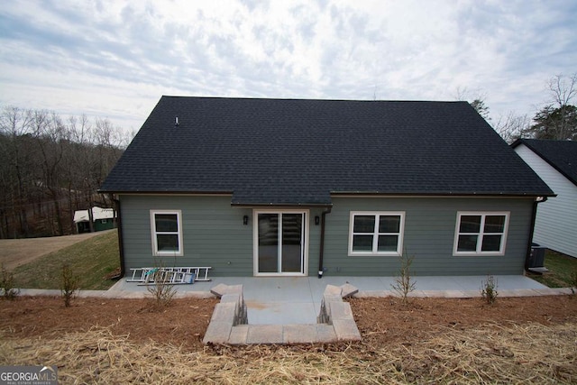 back of property featuring a shingled roof, a patio, and central AC unit