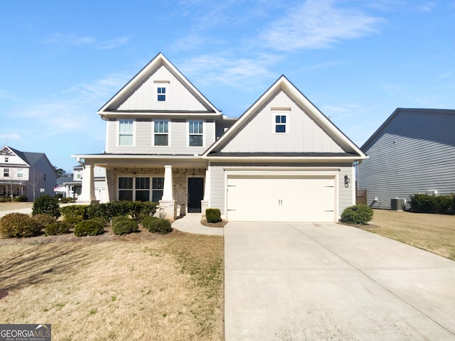 view of front of property featuring an attached garage, covered porch, concrete driveway, board and batten siding, and a front yard