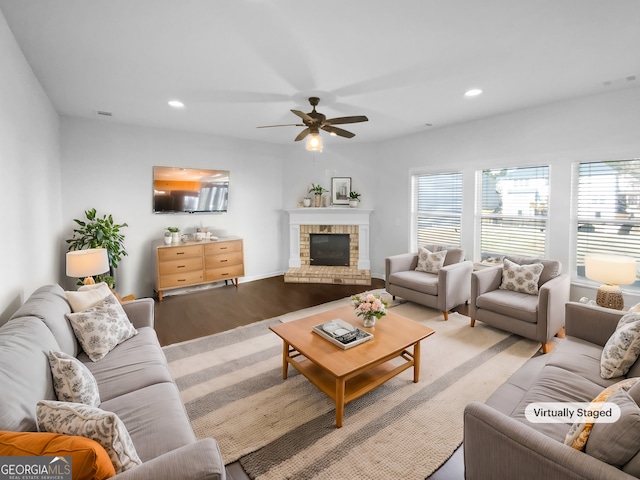 living room featuring visible vents, a ceiling fan, wood finished floors, a brick fireplace, and recessed lighting